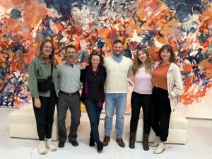 Artists at the residency in front of a painting by the Residency's founder, Neltje. From left to right: Amber Eve Anderson (artist), Michael Heyman (poet), Diana Horowitz (painter), Matthew Greenberg (composer), Kerry Dolan (writer), and Gretchen Schaefer (artist).